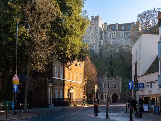 A street in Windsor with the castle walls above